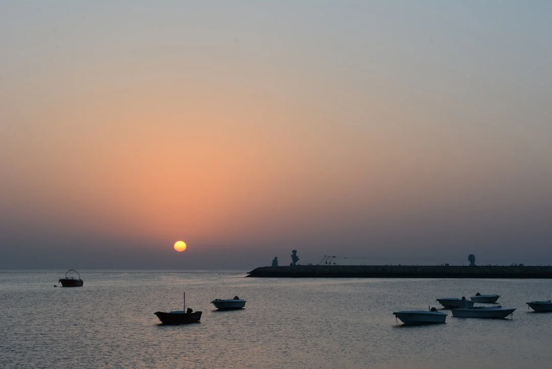Golden sunset over Hurghada’s marina with dive boats moored, hinting at easy transfers south to Makadi Bay.