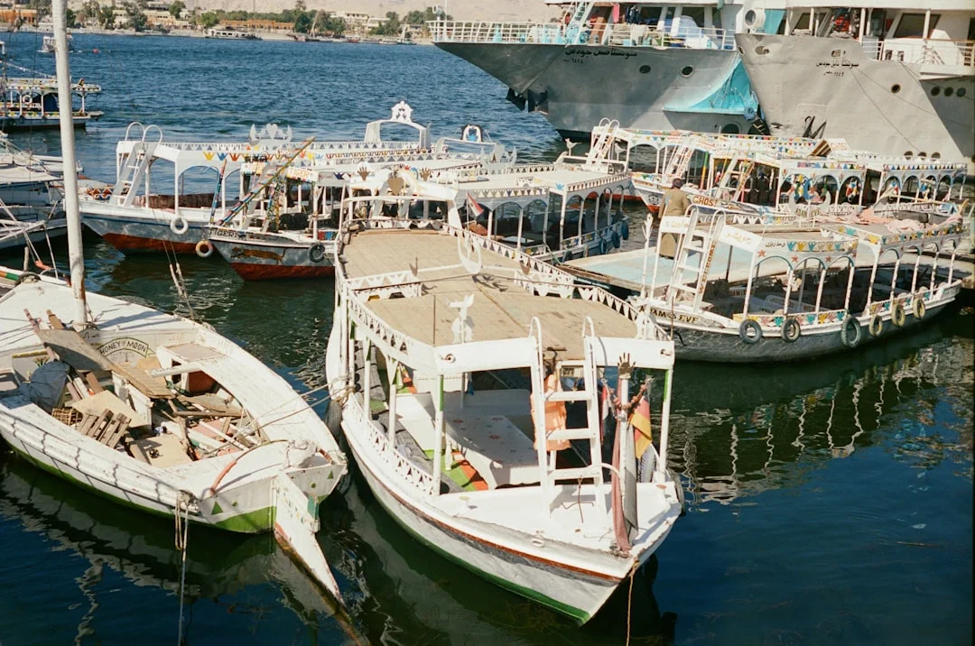 A family with children boarding a boat in Sharm El Sheikh with calm blue water in the background.