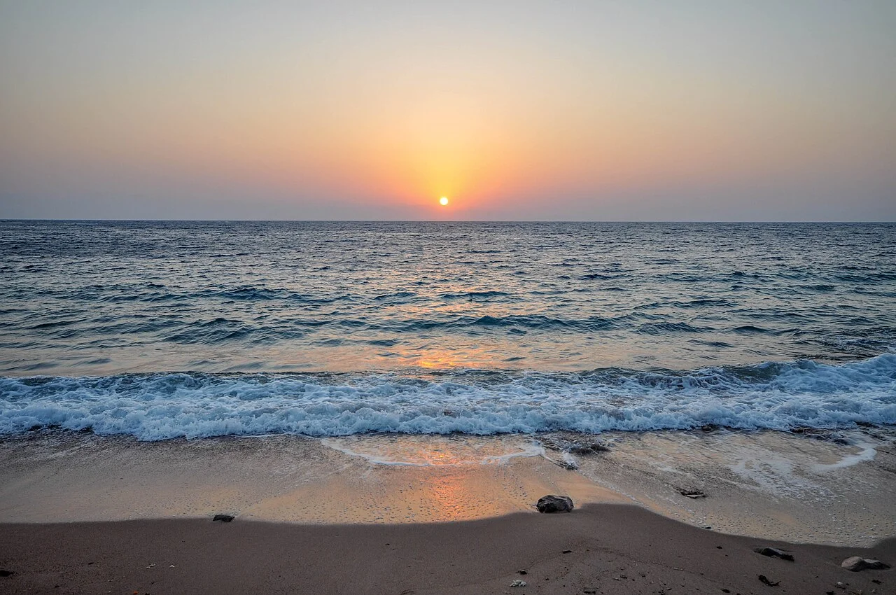 Taxi pickup area outside Hurghada International Airport with drivers offering rides